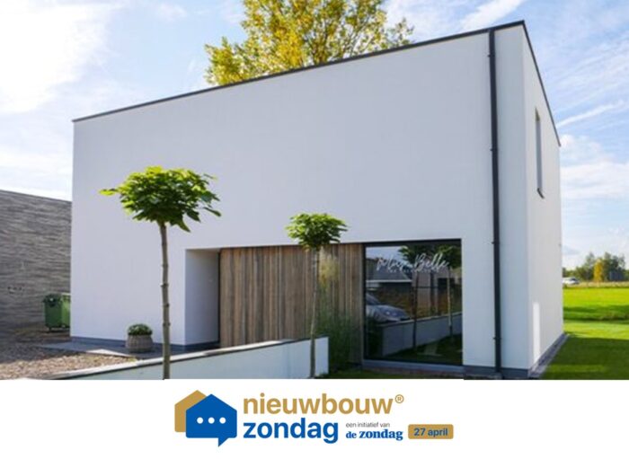 Moderne, witte, rechthoekige woning met een plat dak, grote ramen en een minimalistisch design. Er staat een boom voor en er is gras rondom het pand. Het logo van Nieuwbouw Zondag staat onderaan de afbeelding.