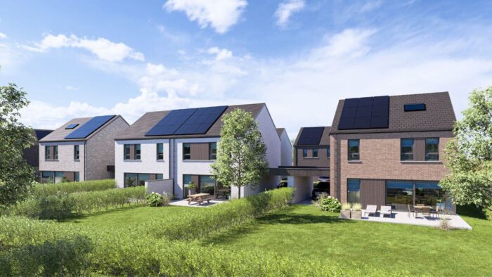 Een rij moderne huizen van twee verdiepingen met zonnepanelen op de daken, grote ramen en omheinde achtertuinen met patio's, omringd door groene gazons en bomen onder een blauwe lucht met wolken.