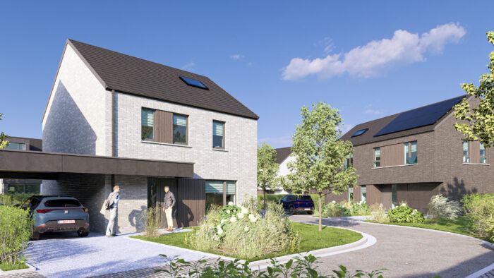 Un quartier résidentiel moderne composé de maisons à deux étages, de jardins aménagés, de voitures garées et de deux personnes qui discutent près d'une allée, sous un ciel bleu limpide. Certaines maisons sont équipées de panneaux solaires sur leurs toits.
