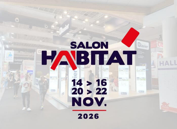 Des personnes se promènent dans un hall d'exposition moderne où sont installés des stands. Un texte superposé indique : « Salon Habitat, du 14 au 16 et du 20 au 22 novembre 2026 ». Le logo de l'événement occupe une place centrale sur l'image.