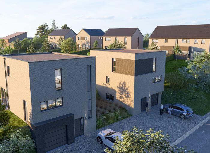 Un quartier résidentiel moderne composé de maisons à deux étages, aux toits plats, dotées de grandes fenêtres et d'allées où sont garées des voitures. Des arbres et des arbustes verdoyants entourent les maisons, et d'autres habitations sont visibles à l'arrière-plan.